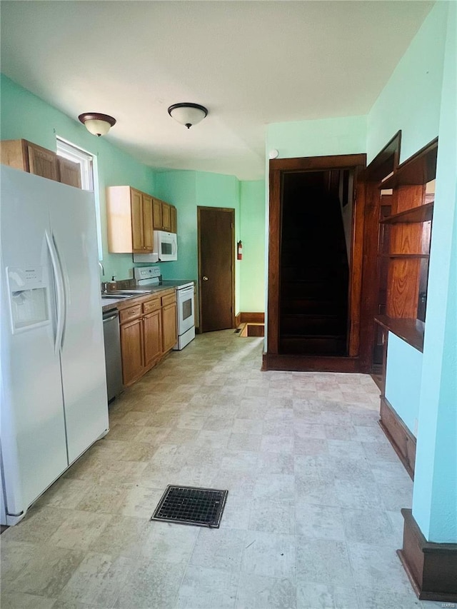 kitchen featuring white appliances and sink