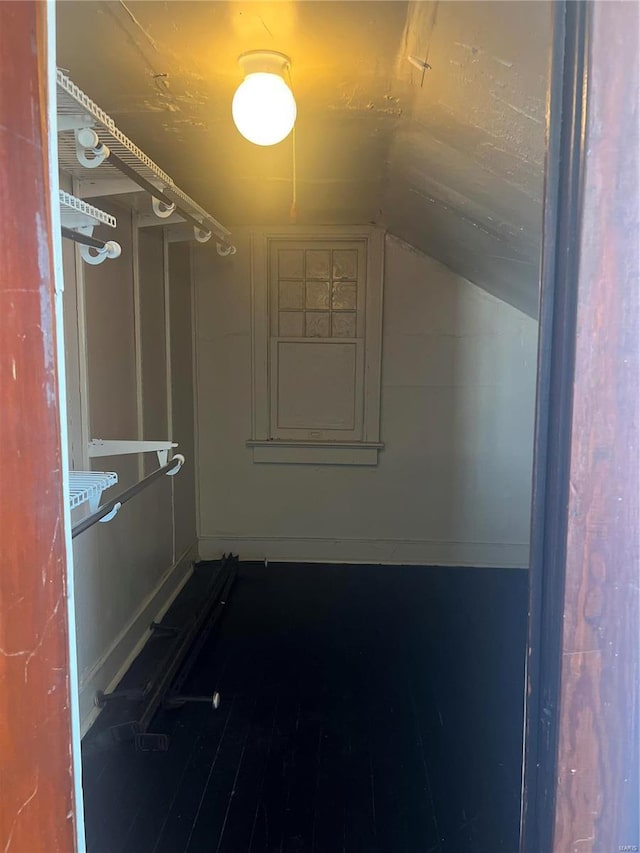 spacious closet with lofted ceiling and hardwood / wood-style floors