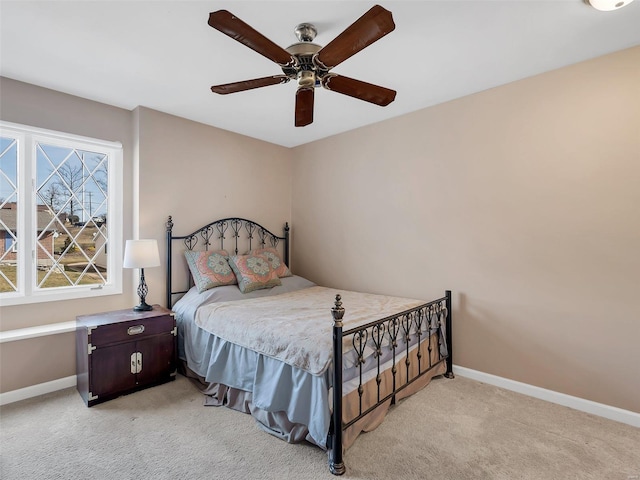 bedroom featuring light carpet and ceiling fan