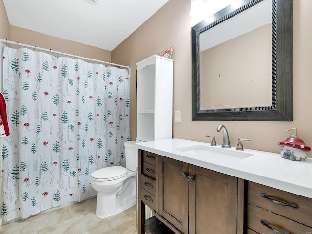 bathroom featuring vanity, tile patterned floors, and toilet