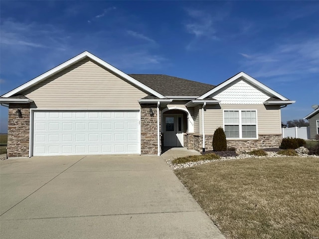 view of front of house featuring a garage and a front lawn