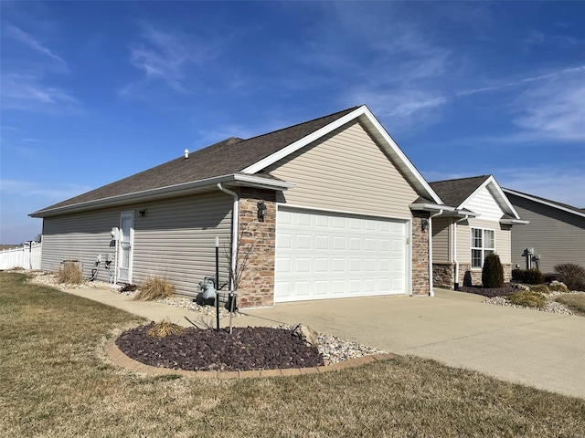 view of side of home featuring a yard and a garage