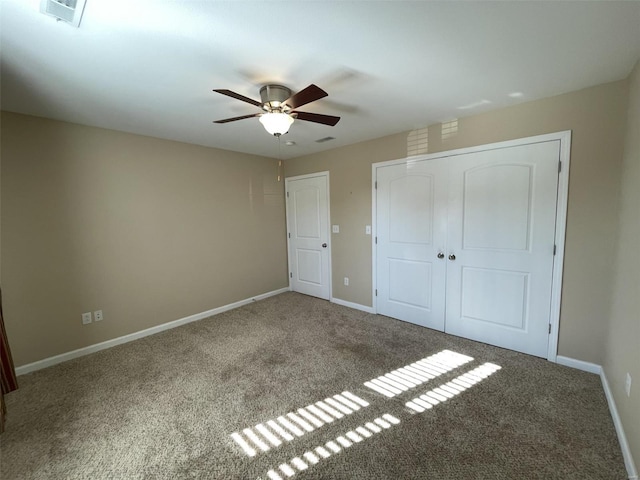 unfurnished bedroom with ceiling fan, carpet floors, and a closet