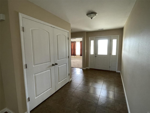 foyer with dark tile patterned floors