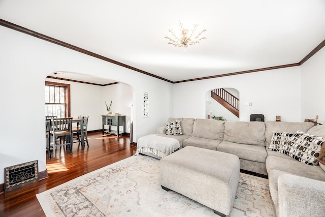 living room featuring hardwood / wood-style flooring, crown molding, and heating unit