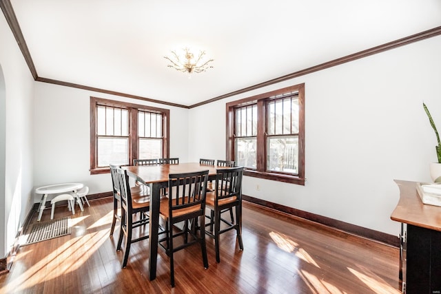 dining area with ornamental molding and dark hardwood / wood-style floors