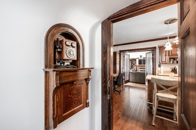 hall featuring crown molding and hardwood / wood-style floors