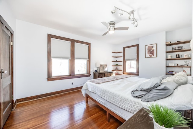 bedroom with ceiling fan and wood-type flooring