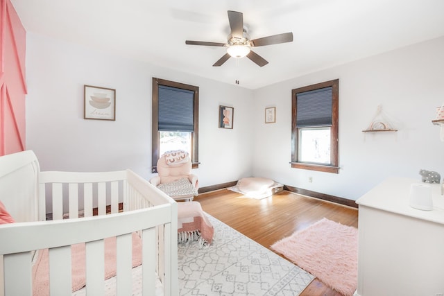 bedroom with ceiling fan and wood-type flooring