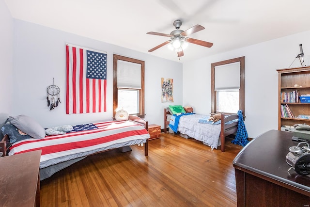 bedroom with wood-type flooring and ceiling fan