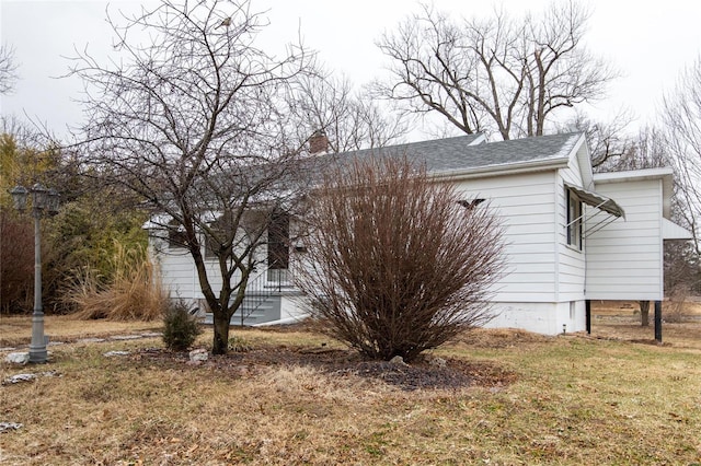 view of side of property with a lawn