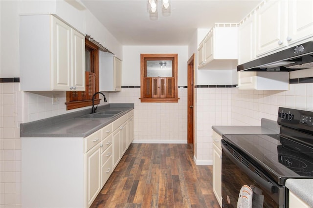 kitchen featuring sink, dark wood-type flooring, white cabinetry, tile walls, and black / electric stove