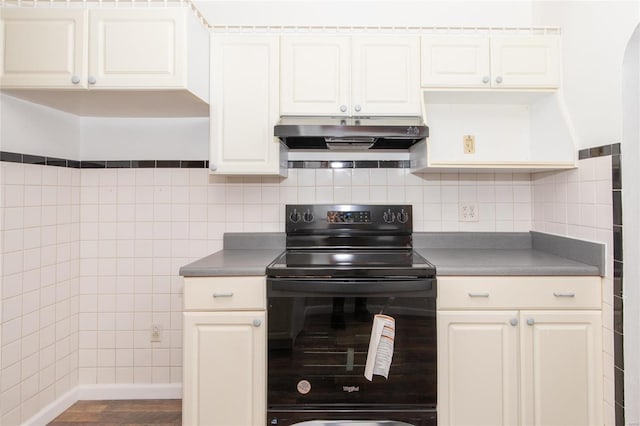 kitchen with white cabinetry, black electric range, decorative backsplash, and hardwood / wood-style flooring