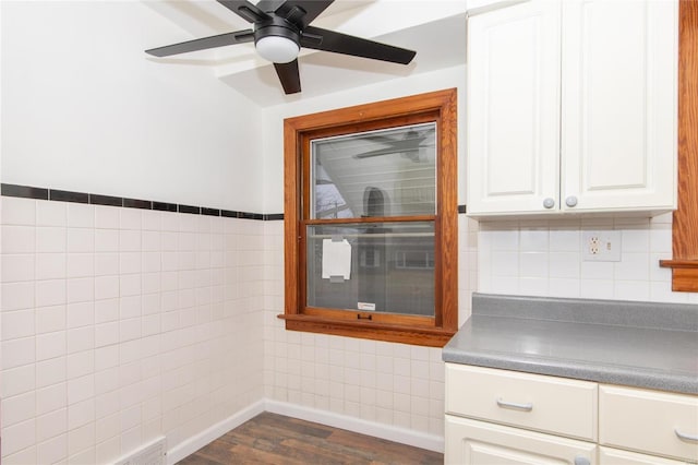 kitchen with white cabinetry, dark wood-type flooring, tile walls, and ceiling fan