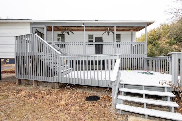 back of house with a wooden deck and ceiling fan