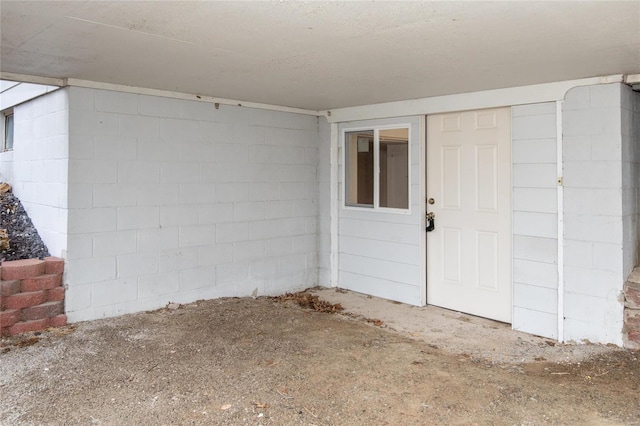 doorway to property with concrete block siding