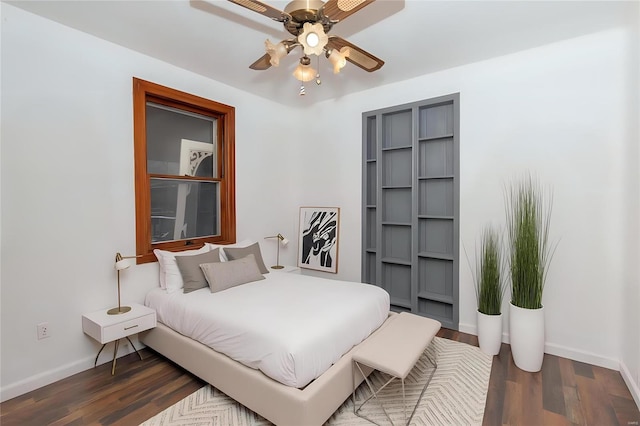 bedroom with a ceiling fan, baseboards, and wood finished floors