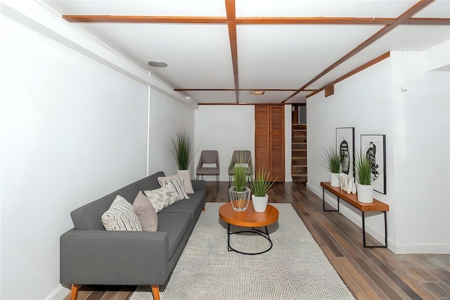 living room featuring baseboards, stairway, and wood finished floors