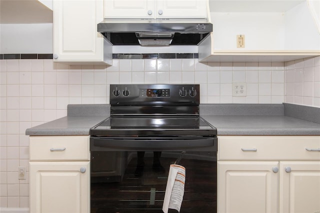 kitchen with dark countertops, under cabinet range hood, and black / electric stove