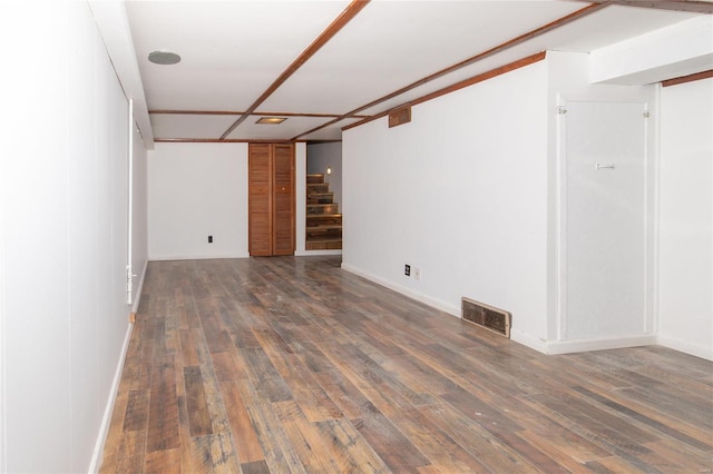 finished basement with stairs, hardwood / wood-style floors, and visible vents