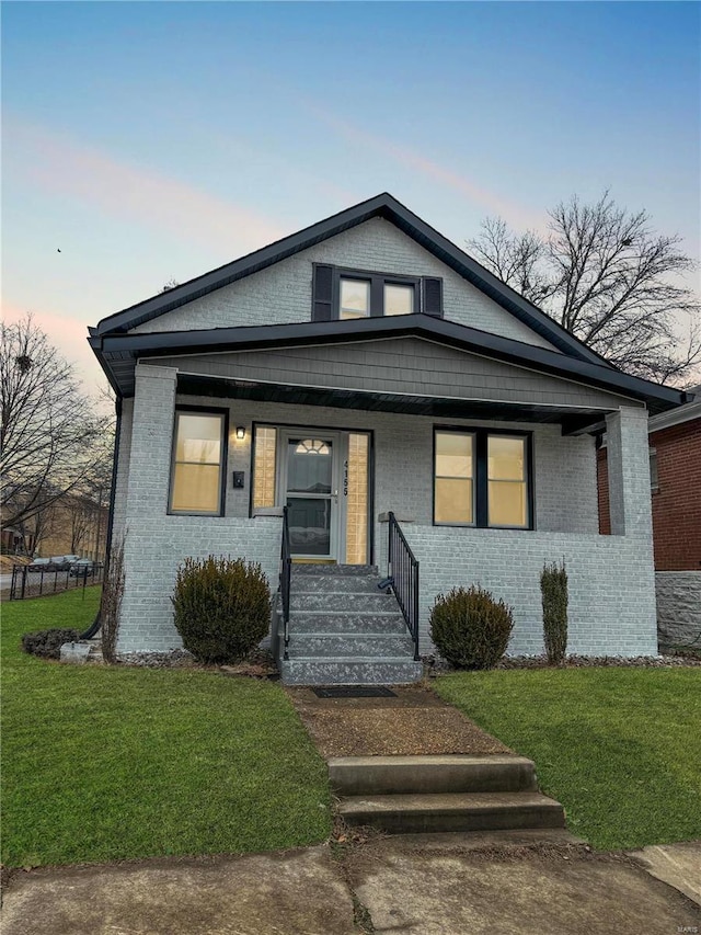 view of front facade featuring a yard and covered porch