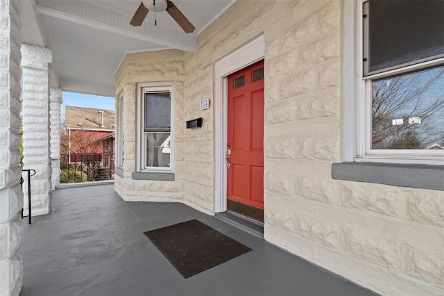 entrance to property featuring ceiling fan and a porch