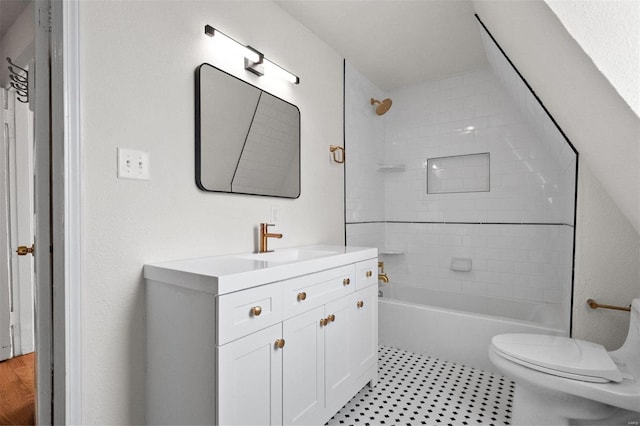 full bathroom featuring vanity, toilet, tile patterned floors, and tiled shower / bath