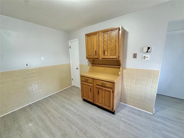 kitchen featuring light hardwood / wood-style floors and tile walls