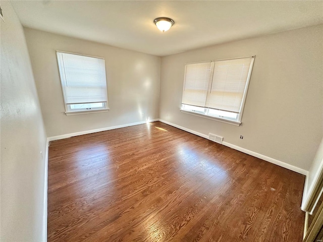 unfurnished room featuring dark wood-type flooring