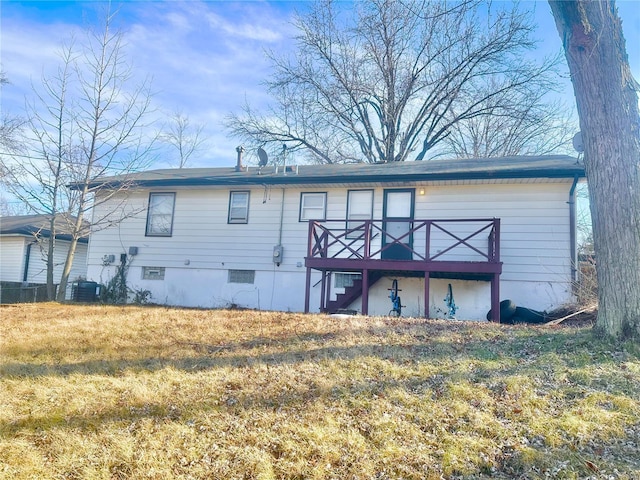 back of house with central AC, a yard, and a deck