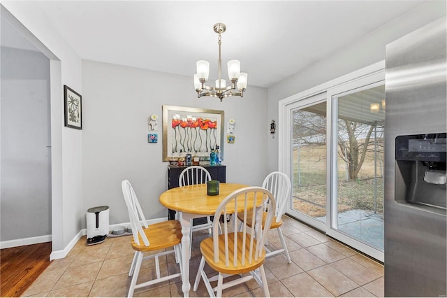 dining room with an inviting chandelier and light tile patterned floors