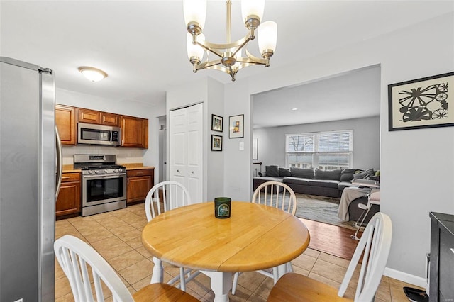 dining room featuring light tile patterned floors and a notable chandelier