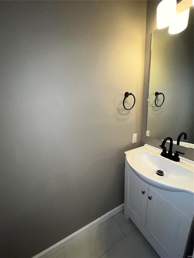 bathroom featuring baseboards, vanity, and tile patterned flooring