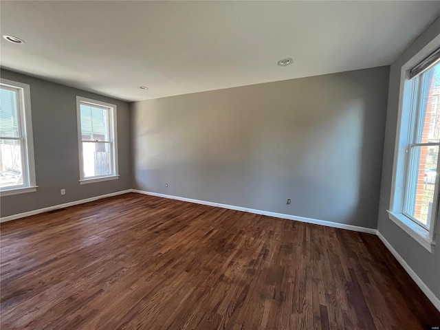 unfurnished room with a healthy amount of sunlight and baseboards