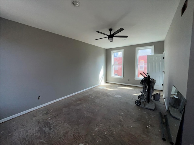 interior space featuring baseboards and ceiling fan