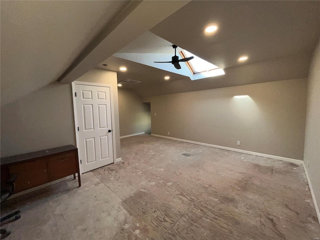 bonus room with visible vents, vaulted ceiling with skylight, and baseboards