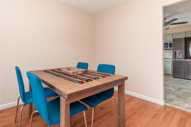 dining room featuring light wood-type flooring and ceiling fan