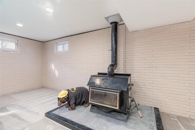 interior details with carpet and a wood stove