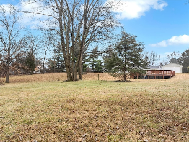 view of yard featuring a rural view and a wooden deck