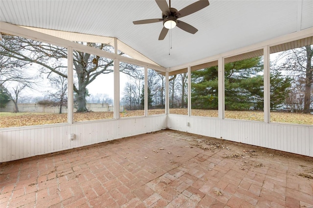 unfurnished sunroom featuring lofted ceiling and a ceiling fan