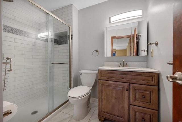 full bathroom featuring toilet, marble finish floor, a shower stall, and vanity