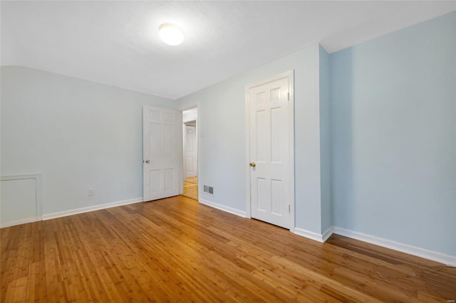 unfurnished bedroom featuring light wood-type flooring, visible vents, and baseboards