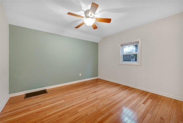 unfurnished room featuring a ceiling fan, visible vents, vaulted ceiling, baseboards, and light wood-type flooring