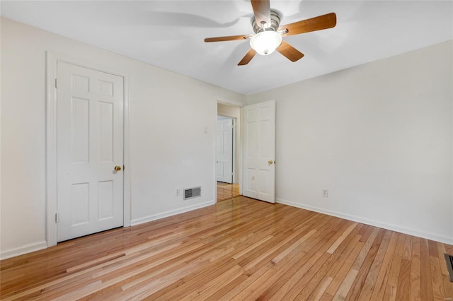 unfurnished bedroom with a ceiling fan, baseboards, visible vents, and light wood finished floors