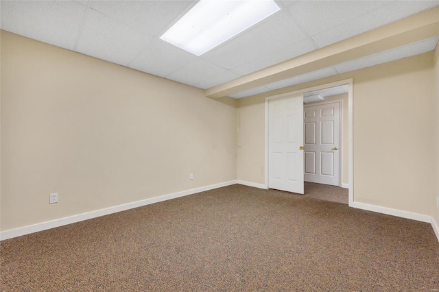 unfurnished room with carpet floors, a paneled ceiling, and baseboards