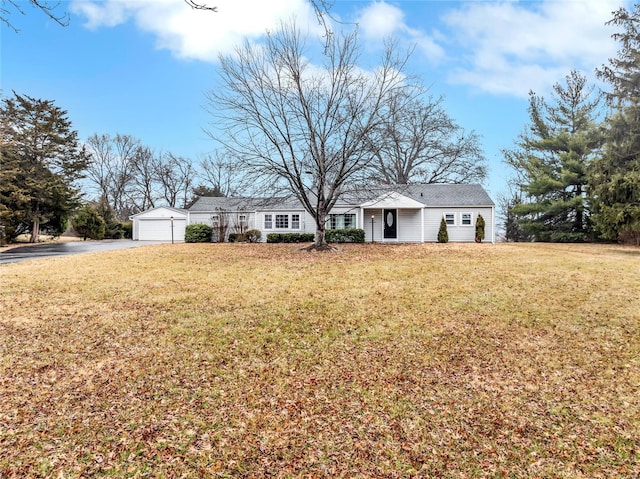 ranch-style house with a garage and a front lawn