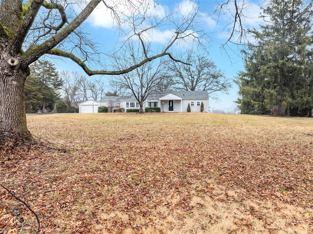 view of front of home with an outbuilding and a front yard