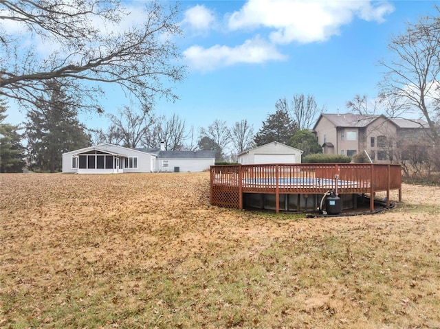 view of yard featuring a wooden deck and a sunroom