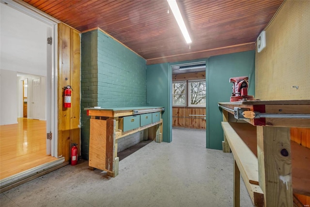 interior space featuring wooden ceiling and a workshop area