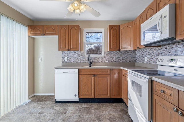 kitchen featuring tasteful backsplash, sink, white appliances, and ceiling fan